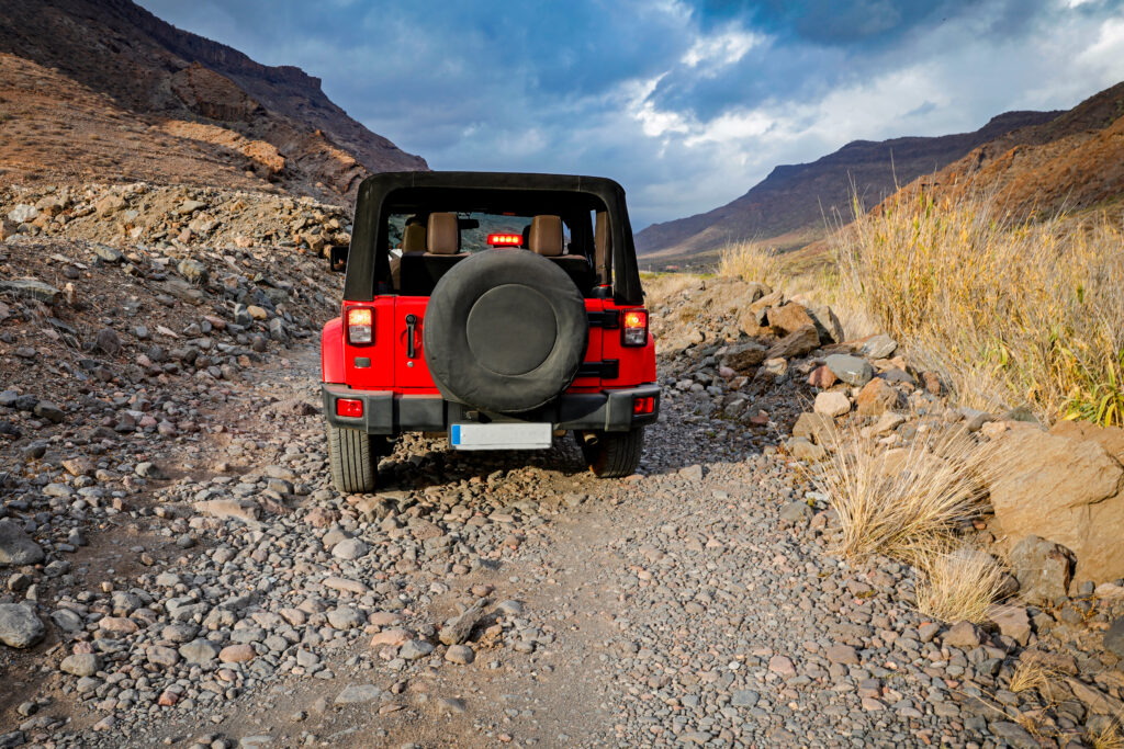 red jeep driving in desert